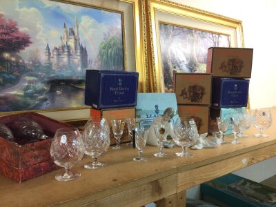 A collection of boxed Royal Doulton glassware and two Lladro figures
