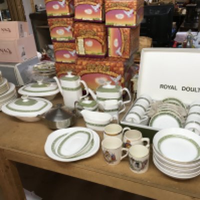 A Royal Doulton dinner set including plates, cups etc . Also includes Four commemorative mugs . NO RESERVE