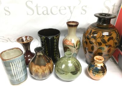 A box of various studio pottery vases including examples by Leach and others.