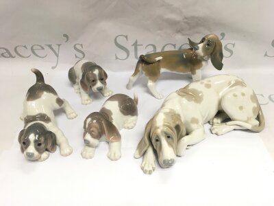 Five Lladro figures of dogs.