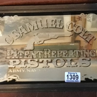 A 20th century advertisement mirror Samuel Colt Pistols.- NO RESERVE