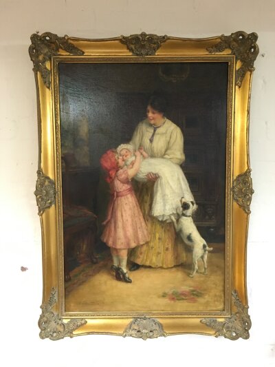 G Sheridan Knowles 1863-1931. A gilt framed oil on canvas of a mother nursing an infant with a child and dog beside her, approx 75cm x 108cm.