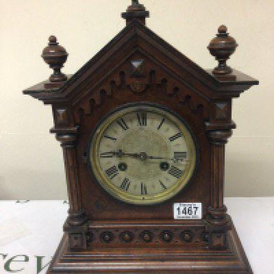 A late Victorian walnut clock with turned finials silvered dial. Height 42cm- NO RESERVE