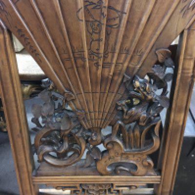 A Chinese chair the backed carved with dragons flowers and a fan above a drop in seat on scrolled Legs .- NO RESERVE