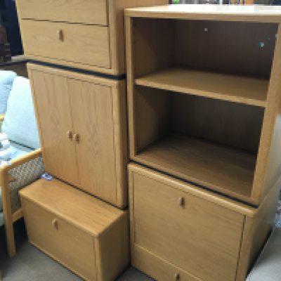 A modern design light oak open bookcase and conforming cabinets with drawers and cupboards.- NO RESERVE