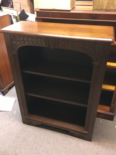 An oak bookcase with carved design 75cm wide, 98cm tall