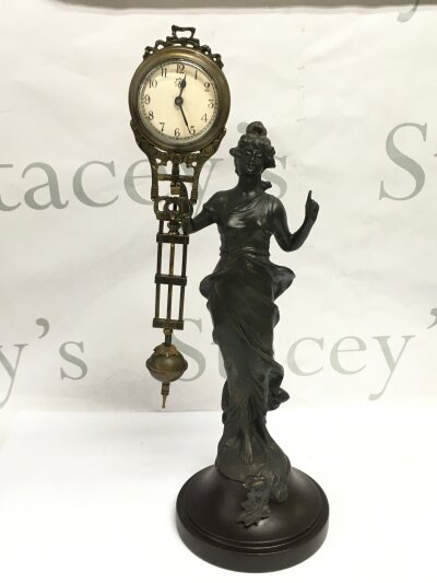A figural mystery clock, approx height 34cm.