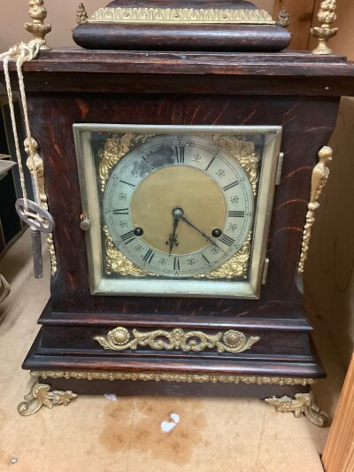 A oak cased  chimingmantle clock with gilt mounts the dial with Roman numerals