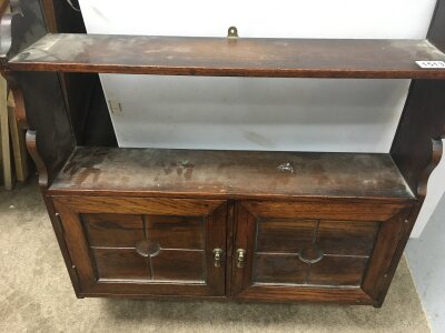 A small oak hanging wall cabinet, with panelled style doors.