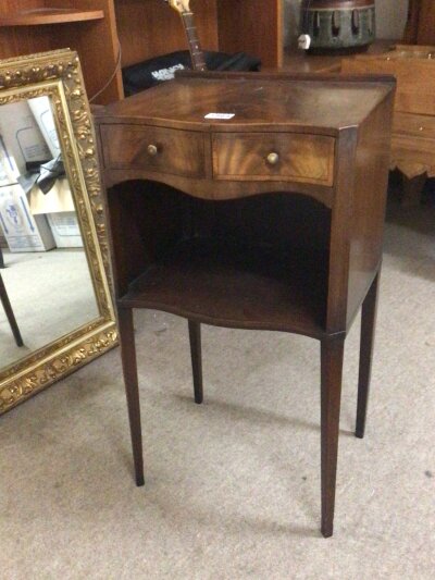 A George III style Mahogany cabinet with a cross banded top serpentine front and two small drawers above an open section.