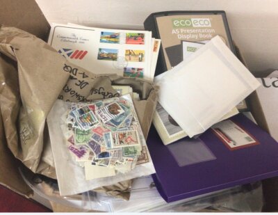 A box containing first day covers playing cards a few presentation packs and albums containing post office picture cards PHQ.