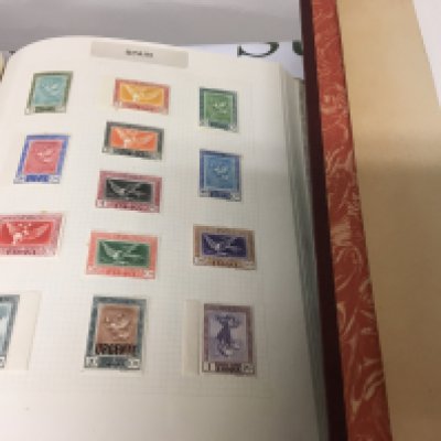 A Box containing Six albums of stamps including American stamps two albums of QEII stamps unmounted mint and other world stamps