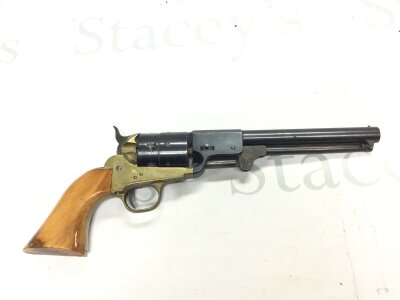 A blank firing replica revolver with brass trigger guard and walnut grip.