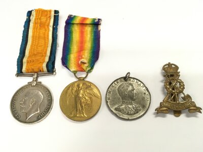 WW1 War and Victory medal group presented to 190991 GNR .F.O STONE .R .A, a cap badge and a King Edward VIII 1937 commemorative medallion