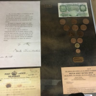 A framed collection of WW11 artefacts.- NO RESERVE