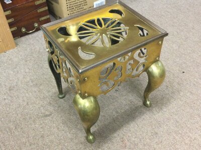 A Victorian brass fire trivet with pierced details. 34cm tall 33cm wide 30cm long approximately