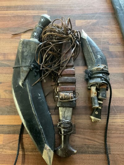 Two Indian swords together with  three Kukri  knives.