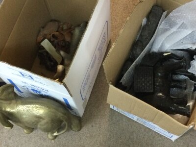 A large collection of various cast and carved elephant figures.