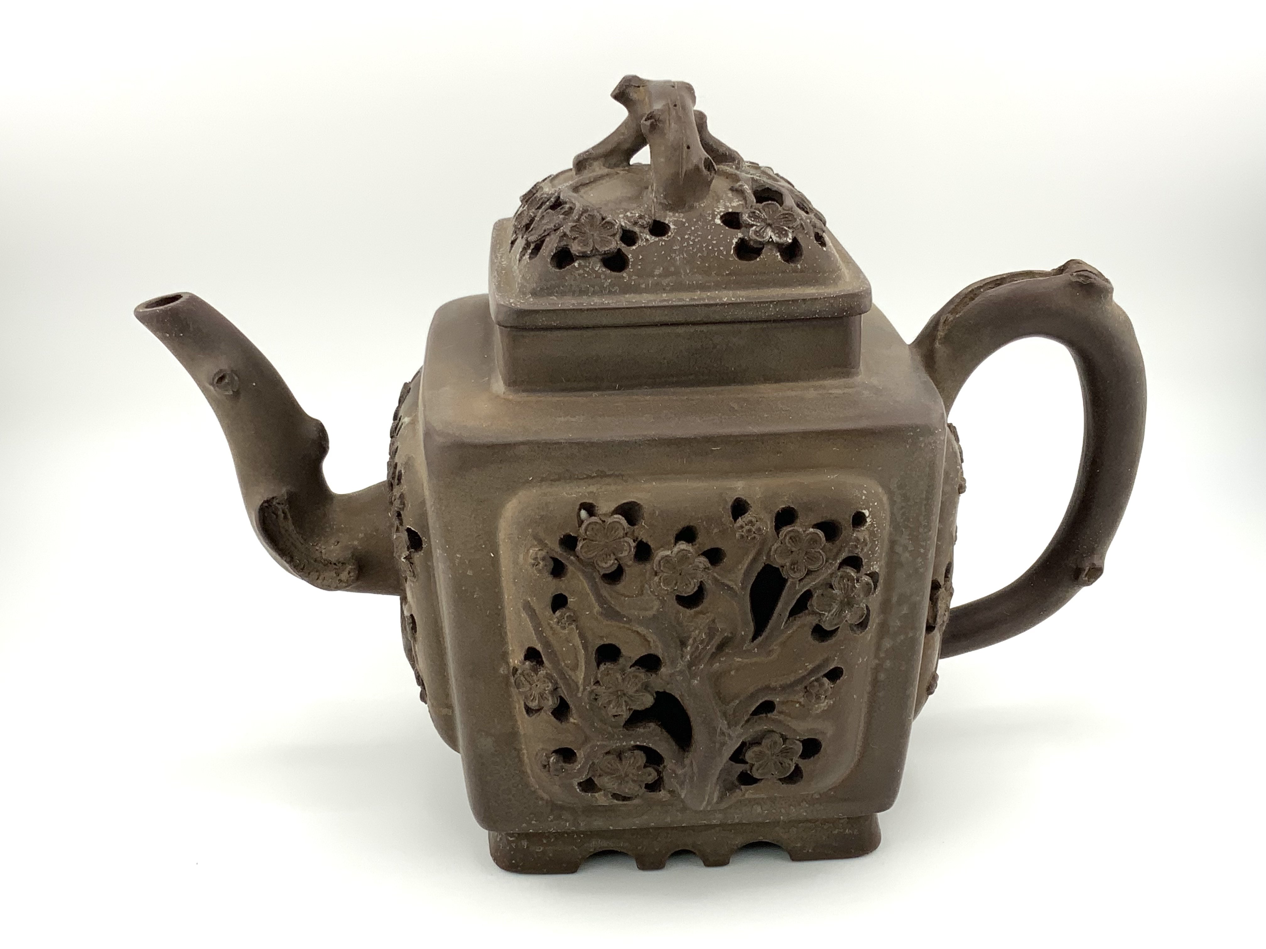 A square from Chinese Yi-Xing terracotta teapot with pierced cherry blossom decoration and impressed character mark to the underside.- NO RESERVE