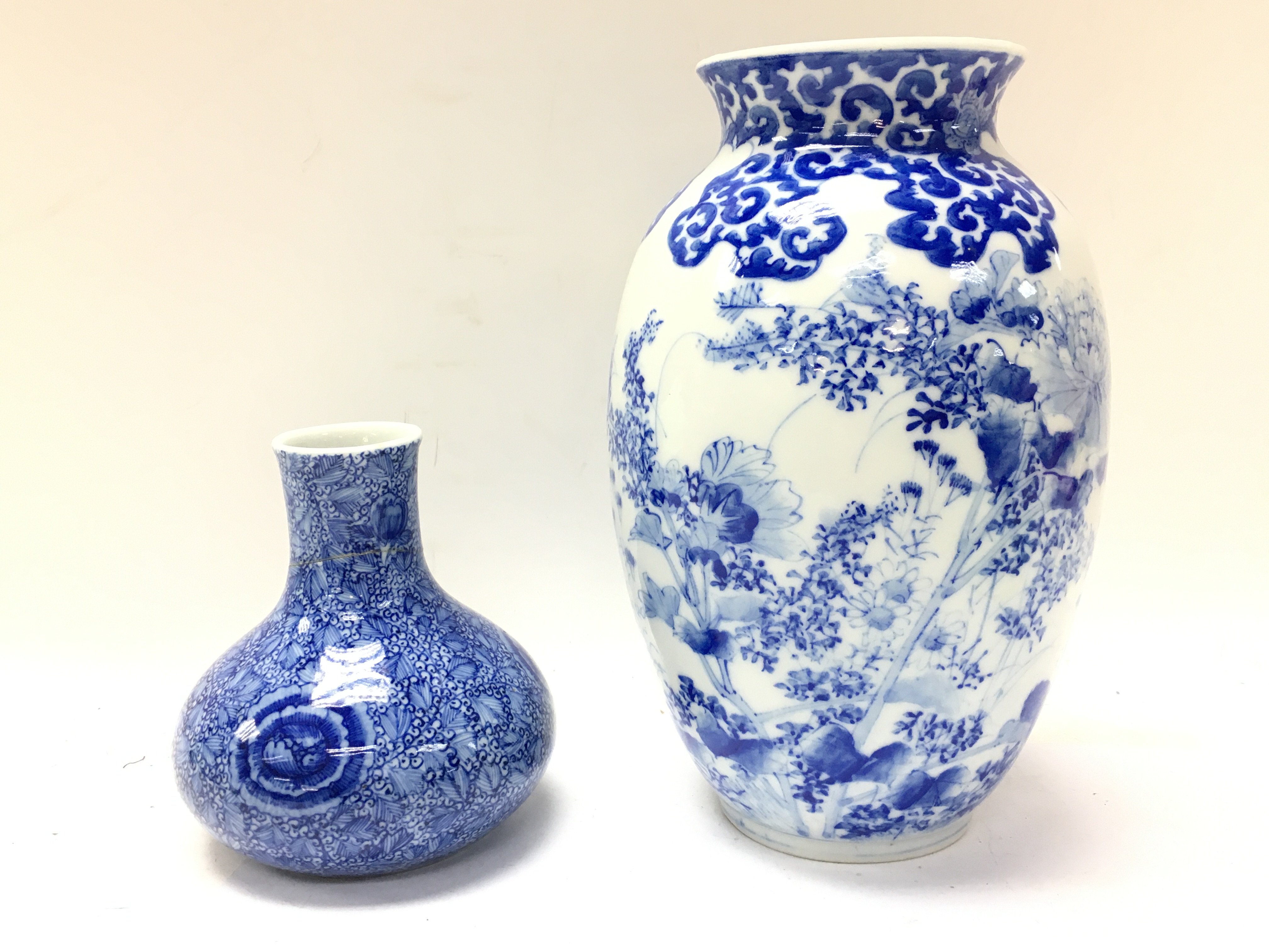 Chinese blue and white vases with floral decoration, one with restoration. 11 and 22cm tall. Postage category D- NO RESERVE
