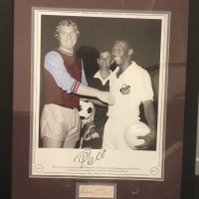 Pele + Bobby Moore Signed Framed Picture: Large Ltd edition print of Moore in West Ham kit and Pele in Santos kit in 1970. Pele has signed the print number 39/75 and there is a Coa from a reputable source. Additionally Bobby Moores autograph on card has been added to border. Expensively framed with claret and blue mount.