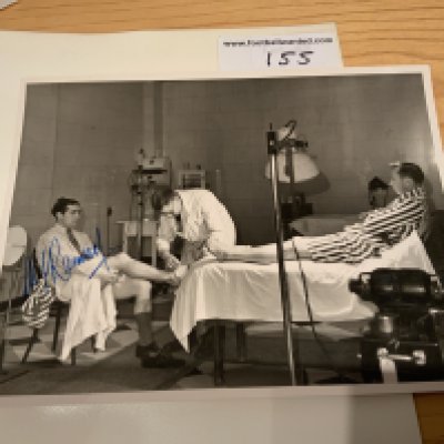 Alf Ramsey Tottenham Signed Football Press Photos: Superb photo depicting Ramsey receiving treatment in the treatment room with Ron Burgess on the bed awaiting his treatment. Signed clearly without dedication by Ramsey. Press stamp to rear.