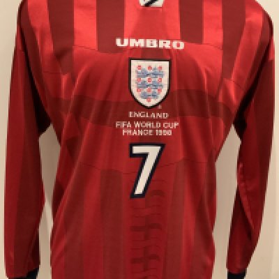 David Beckham 1998 World Cup Tournament Issued Football Shirt: Red long sleeve Umbro shirt with number 7 Beckham to rear. Front has England badge under Umbro then the words England FIFA World Cup France 1998 above number 7. Given by Davids father to vendor and not to be mixed up with similar replicas which have slight differences including the R copyright placement. Excellent.