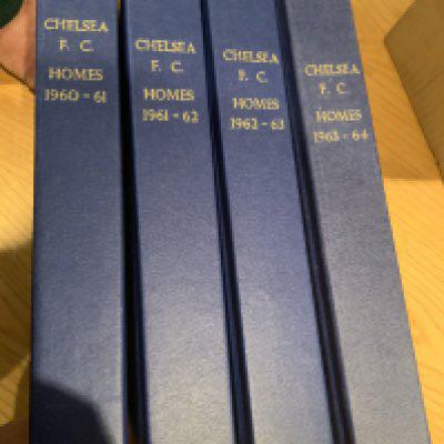 60/61 - 63/64 Chelsea Home Football Programmes: Complete home football programmes including cup matches in blue binders with gold lettering stating Chelsea FC Homes and season. A few have score to cover and 60/61 season has a lot of tokens missing. (4 seasons)