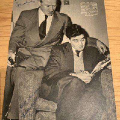 Matt Busby Signed Manchester United Football Picture: Full size black and white magazine picture depicting Busby helping Jackie Blanchflower with his crossword. Signed clearly without dedication by both.