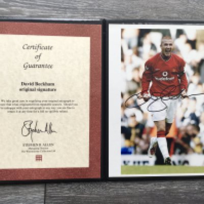 Manchester United Signed Football Photos: Genuine photo of Beckham in Manchester United kit with certificate and folder from the reputable Westminster Collection. Bobby Charlton signed FDC by reputable Autographed Editions. Other autographs on various paper items include Robson, P + G Neville Wilkins and Bailey.