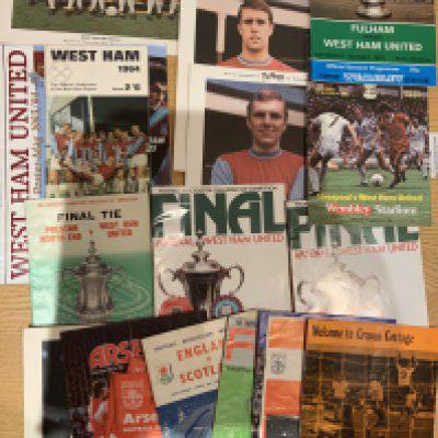 West Ham Football Memorabilia: Mint condition large Typhoo cards of a mid 60s team group plus 2 Bobby Moores and a Geoff Hurst. 1964 cup final handbook and programme, final programmes for 75 and 80 and more. Instructions to sell.