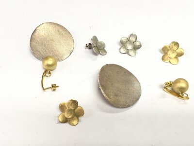 Three pairs of silver/white metal earrings including Helo examples.
