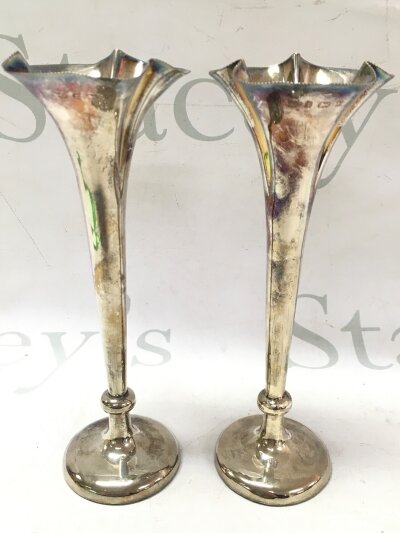A pair of loaded base silver hallmarked vases, 19cm tall. 355g