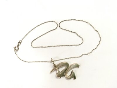 A Tiffany & Co necklace and chain.