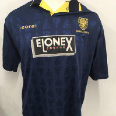 Wimbledon 1995 - 1996 Match Worn Football Shirt: Blue short sleeve Elonex sponsored home shirt. Made by Core with Crazy Gang neck label. Premier League badging to arms. Number 18 Ardley to rear.