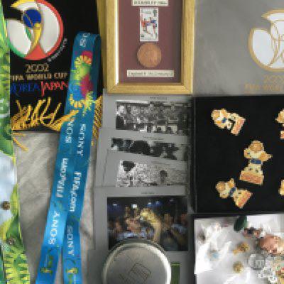 World Cup Football Memorabilia: 2002 World Cup quality pennant given to sponsor, 1966 World Cup stamp framed with 1966 one penny, lanyards, postcards, Coca Cola Football badges and some other badges mainly picked up at tournaments.