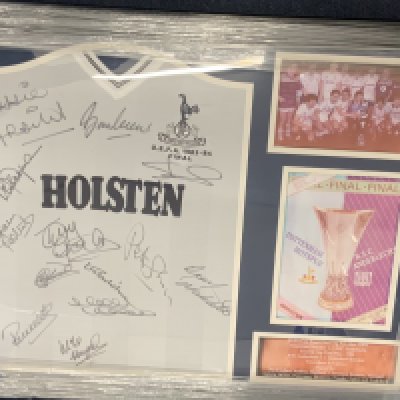 Tottenham 1984 UEFA Cup Final Signed Framed Football Shirt: Replica white Holsten shirt with UEFA 1983-84 Final embroidered to breast. Signed clearly to front by Burkinshaw Shreeves Ardiles Perryman Mabbutt Roberts Hazard Clemence Falco Galvin Miller Crooks and Archibald. Photographic proof on COA from a reputable source.