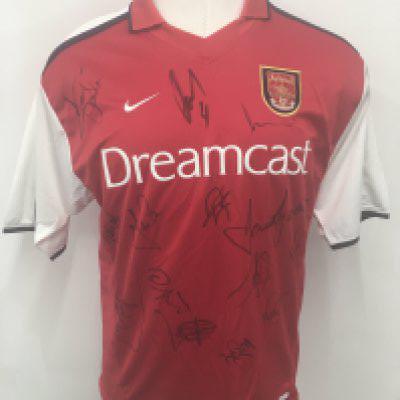 Arsenal 2000 - 2002 Signed Football Shirt: Red short sleeve unused Dreamcast sponsored large shirt. Signed to front by 14 players including Seaman and Adams. Obtained by Paul Merson.