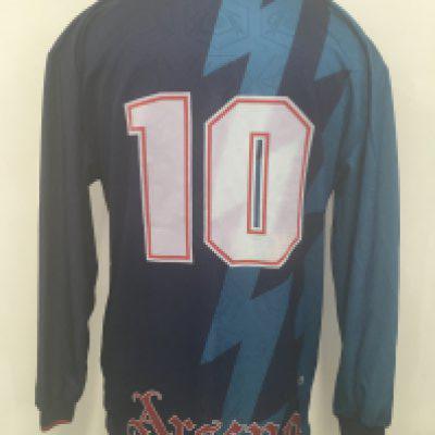 1995 - 1996 Arsenal Away Signed Football Shirt: Number 10 long sleeve shirt signed to front by 9 players although not clear signatures. Includes Dixon and Merson. Shirt like new and possibly never worn. Obtained by Merson but without sleeve patches so not being sold as a Bergkamp match worn.