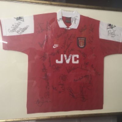 95/96 Paul Merson Arsenal Match Worn Signed Testimonial Football Shirt: Short sleeve red home shirt with Bould 5 to rear. Worn in Paul Merson testimonial match in May 1996 and presented back to Merson after being signed by both teams. Paul Gascoigne famously wore an Arsenal kit this day and has signed the shirt along with 27 others. Autographs include Dixon Seaman McLintock George Adams Le Tissier Dikov Houston Rix Wright and Ray Wilkins. Nicely presented in very large frame. Not for posting.