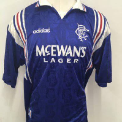 Rangers 1996 Richard Gough Testimonial Match Worn Football Shirt: Blue short sleeve Glasgow Rangers shirt. Adidas McEwans Lager number 7. Sleeve is embroidered with Richard Gough Lionheart Rangers v Arsenal 3 August 1996. Swapped with Arsenal player Paul Merson.