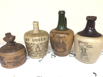 A collection of Victorian and other  stoneware Whisky bottles including the Cream of highland Whisky jubilee blend Glasgow Dewars Perth Whisky bottle John Dewar and Watson of Dundee. (4)