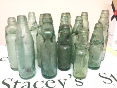 A collection of Victorian and later Codd bottles each with moulded glass labels..