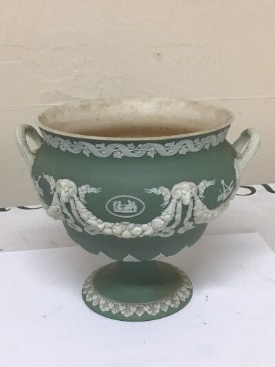 A 19th century Wedgwood green jasper ware urn with neo classical decoration impressed marks Wedgwood to the base the interior with stains Hight 15cm x 18.3cm plus two 20th century ash trays (3)