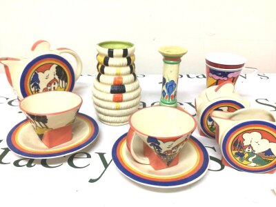 A Clarice Cliff Vase with a shaped side decorated with black yellow and orange an unmarked Crocus pattern candle stick and a Moorland Chelsea tea for two set.