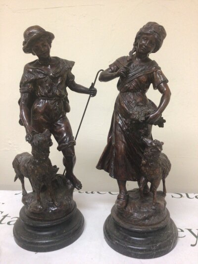 A Pair of late 19th century Spelter figures of a young shepherd and shepherdess with dog and lamp at foot on marble bases height 53cm