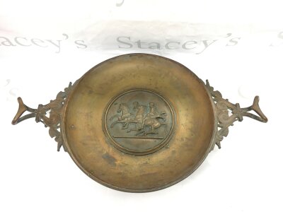 A 19th Century bronze dish with riders and horses in relief to the centre, approx width 48cm.
