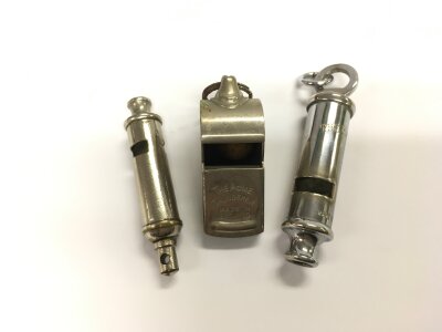 Three vintage whistles.