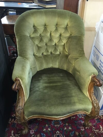 A Victorian armchair with carved design and green velvet upholstery. Dimensions approximately 70cm wide ,90cm long ,92cm tall