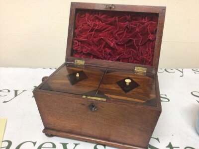 A 19th century Mahogany tea caddy with two hinged compartments one side ring handle missing.